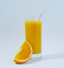 A cup of golden orange juice with a straw and a fresh slice of orange wedge on a light blue background