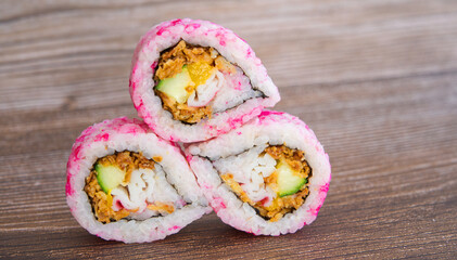 A stack of beautiful sushi on a wooden texture table, delicious food