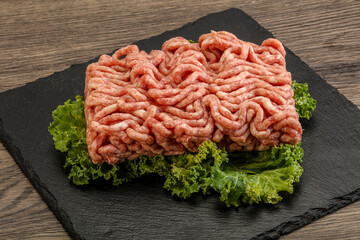 Raw pork minced meat over board