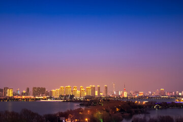Naklejka na ściany i meble Beautiful city night view under colorful sky