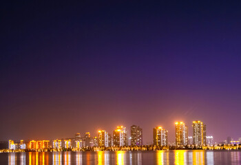 Fototapeta na wymiar Brightly lit tall buildings, beautiful night view of city