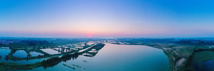 Beautiful lake and surrounding landscape in a Chinese town at sunset