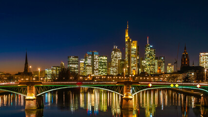 Fototapeta na wymiar Skyscrapers and surrounding buildings by the Frankfurt am Main, Skyline by night, Germany