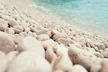 Fototapeta na wymiar Low angle view of beautiful beach with round pebbles. Selective focus
