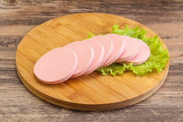 Sliced sausage snak over board © Andrei Starostin