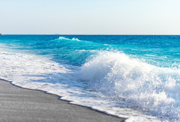 Fototapeta na wymiar Tropical sand beach and blue sky, hot summer day, waves on the beach
