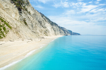 View from above on beautiful coast with white sand and aqua blue water and steep cliffs, Lefkada Ionian island, Greece.