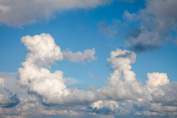 Fototapeta na wymiar Idyllic blue sky with white fluffy clouds in sunny day.