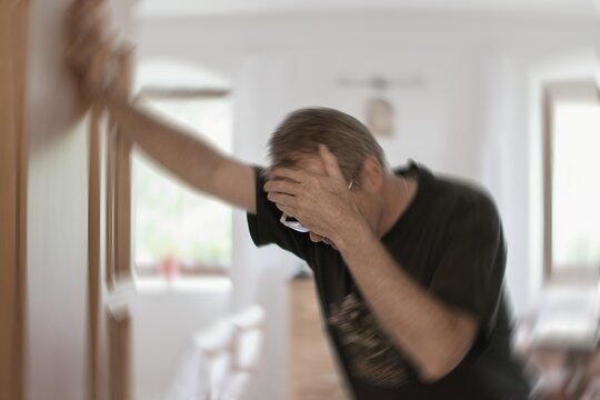 Man suffering from vertigo or dizziness or other health problem of brain or inner ear.