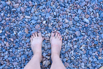 feet on blue pebbles 