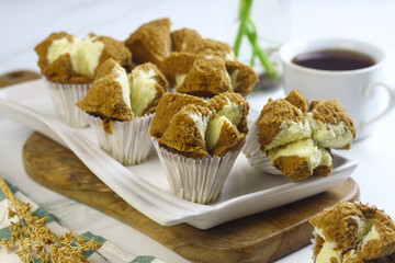 Bolu Kukus Cokelat or Flower bloom steam cake, Indonesian traditional cake, with chocolate flavour. White bright background. Morning tea concept.