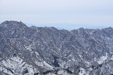 Fototapeta na wymiar Snow-covered landscape at the Great Wall of Jinshanling.