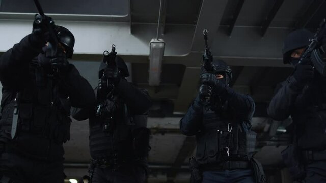 Special ops soldiers storming building. Anti terrorist squad wearing helmets