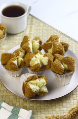 Bolu Kukus Cokelat or Flower bloom steam cake, Indonesian traditional cake, with chocolate flavour. White bright background. Morning tea concept.