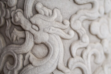The stone is carved into a dragon,A wall with dragon stone sculpture,Chinese dragon.