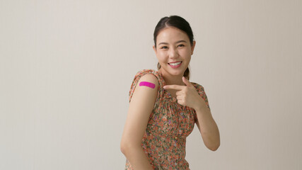 Young attractive beautiful asia female or teenage receive covid-19 anti virus vaccine in campaign...
