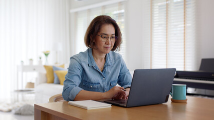 Busy asia smart people or latin sme owner sit on desk table at home enjoy read e-mail on digital tablet, smart wireless wifi 5G in money trade, smile happy female typing write search data on notebook.
