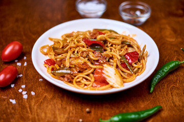 lagman with vegetables, meat in a white plate