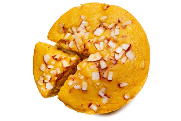 A large-sized ripe palmyra palm fruit cake sprinkled with coconut pieces. Steamed palmyra palm cake in isolated white background.