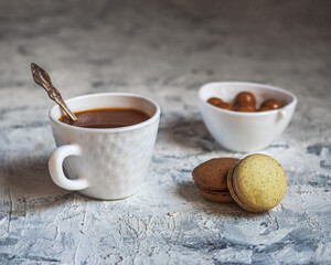 Coffee with caramel and cookies in a white dish