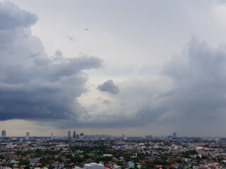 Rain clouds are falling far in the city.