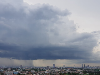 Rain clouds are falling far in the city.