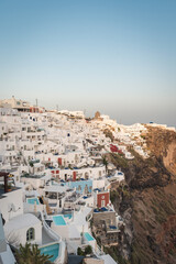 A sunset shot of Imerovigli  village in Santorini island, Greece. Hotels and white houses in the background