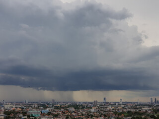 Rain clouds are falling far in the city.