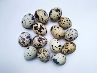quail birds eggs on white background