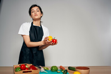 Fototapeta premium cheerful woman in the kitchen housewife cooking vegetables
