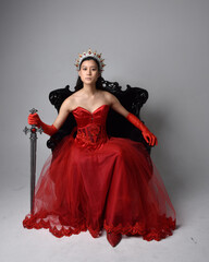 Full length  portrait of beautiful young asian woman wearing red corset, long opera gloves and...