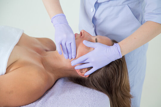 Professional buccal or internal massage of the girl's face