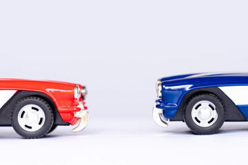 Red and blue cars parked facing each other. On isolated white background with shadow.