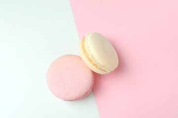 Concept of tasty dessert with macaroons on two tone background
