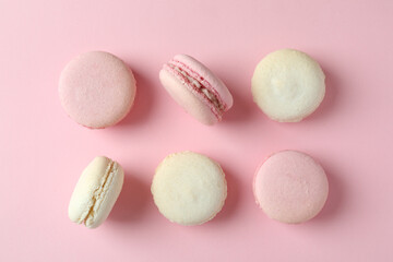 Fototapeta premium Concept of tasty dessert with macaroons on pink background