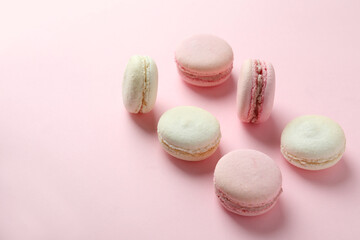 Concept of tasty dessert with macaroons on pink background