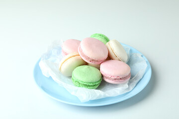 Concept of tasty dessert with macaroons on white background