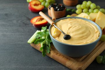 Concept of delicious food with fondue on dark wooden table