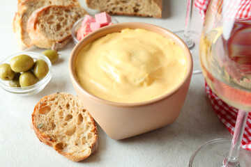 Concept of delicious food with fondue on white textured table