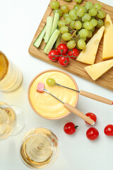 Concept of delicious food with fondue on white background