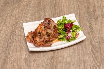Grilled beef steak with side salad on white plate