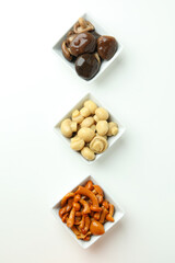 Bowls of marinated mushrooms on white background