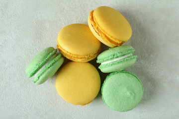 Concept of tasty dessert with macaroons on white textured background