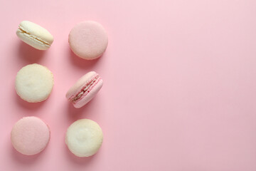 Obraz na płótnie Canvas Concept of tasty dessert with macaroons on pink background