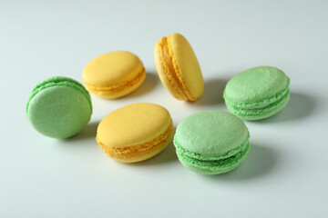 Concept of tasty dessert with macaroons on white background