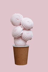 Homemade  marshmallows in a paper cup isolated on pink background
