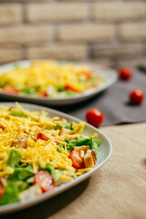 caesar salad on a plate with red tomatoes