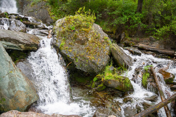 Naklejka na ściany i meble large boulders on the path of a mountain stream