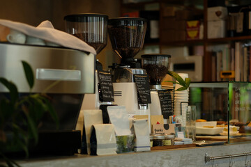 Coffee bar with coffee machines and coffee bean grinder.