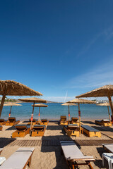 straw umbrellas on the beach at at Puta Zeza beach in Athens in Greece